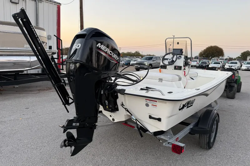 Slide: The Image of 2023 Mako Pro Skiff 15 CC with Mercury 60 engine in a parking lot. - 13