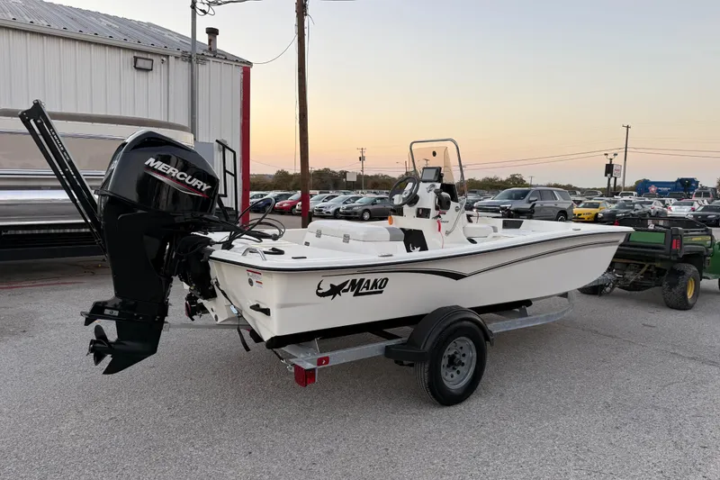 Slide: The Image of 2023 Mako Pro Skiff 15 CC boat with Mercury engine on trailer. - 14