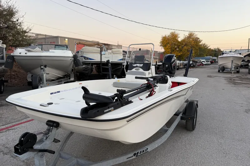 Slide: The Image of 2023 Mako Pro Skiff 15 CC boat with Mercury 60 engine on trailer. - 2