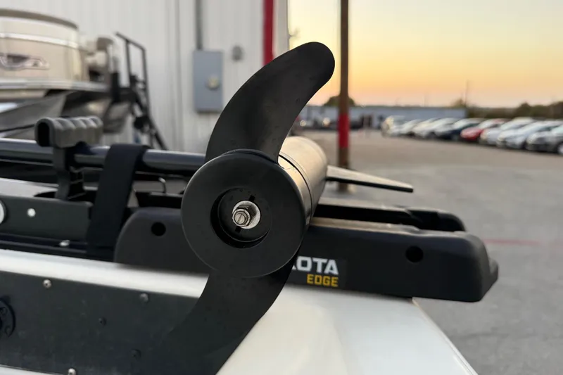 Slide: The Image of 2023 Mako Pro Skiff 15 CC boat in a marina, surrounded by other boats. - 20