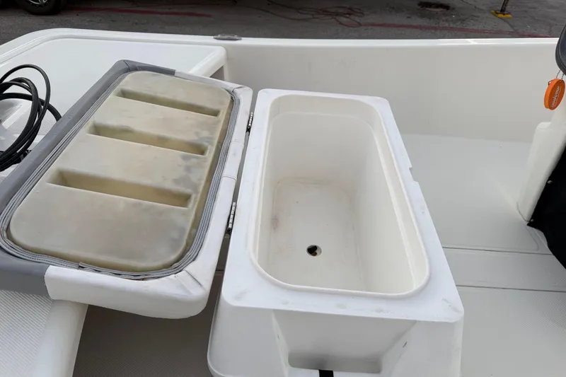 Slide: The Image of 2023 Mako Pro Skiff 15 CC boat interior with seating and Mercury engine. - 25