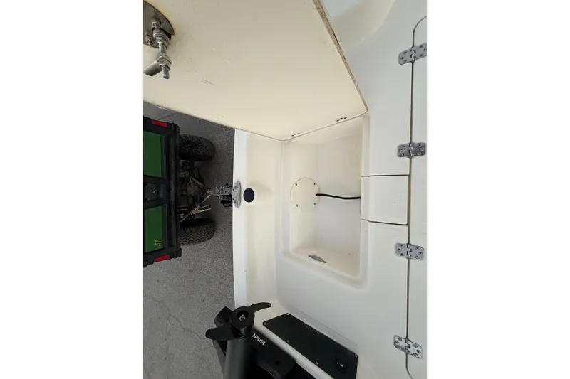 Slide: The Image of 2023 Mako Pro Skiff 15 CC boat in a marina, showcasing seating and controls. - 32