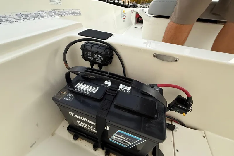 Slide: The Image of 2023 Mako Pro Skiff 15 CC interior storage compartment with battery and support rods. - 35