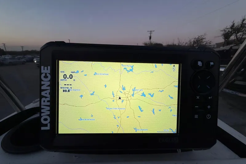 Slide: The Image of Lowrance display on 2023 Mako Pro Skiff 15 CC boat, parked near vehicles and boats. - 38