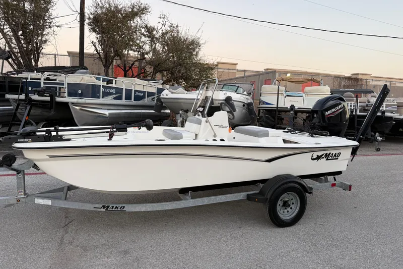 Slide: The Image of 2023 Mako Pro Skiff 15 CC boat on trailer, parked outdoors. - 4