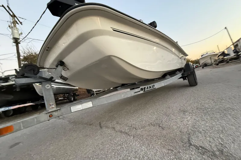 Slide: The Image of 2023 Mako Pro Skiff 15 CC on trailer at sunset, low-angle view. - 45