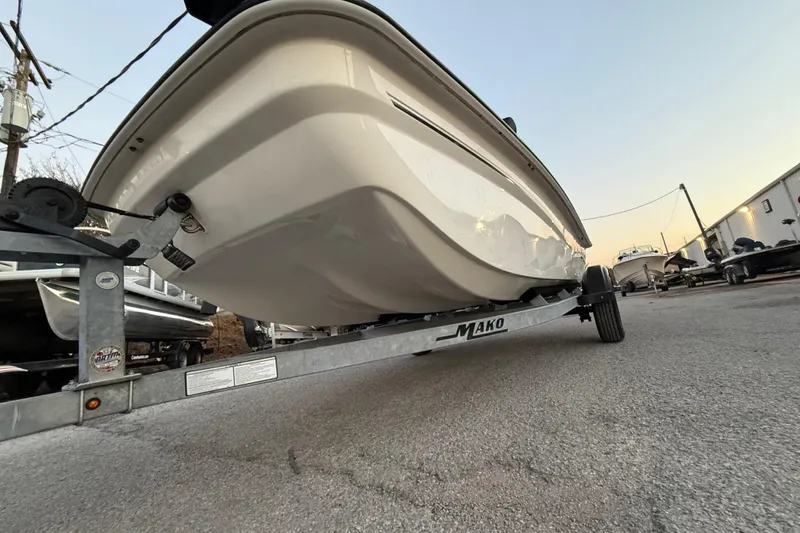 Slide: The Image of 2023 Mako Pro Skiff 15 CC on trailer, low-angle view, outdoor setting. - 46