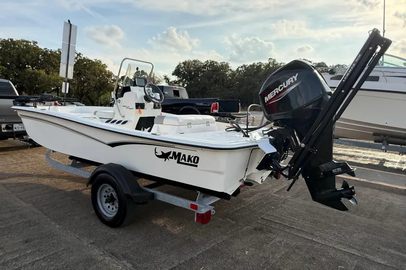 Slide: The Image of 2023 Mako Pro Skiff 15 CC boat on trailer, parked outdoors. - 61