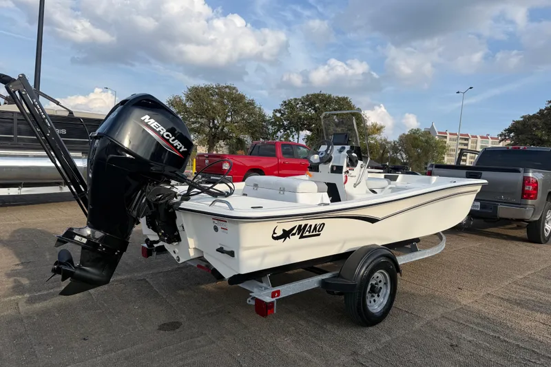 Slide: The Image of 2023 Mako Pro Skiff 15 CC boat on trailer with Mercury engine. - 65