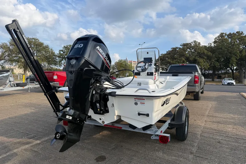 Slide: The Image of 2023 Mako Pro Skiff 15 CC boat on trailer with Mercury outboard motor. - 66
