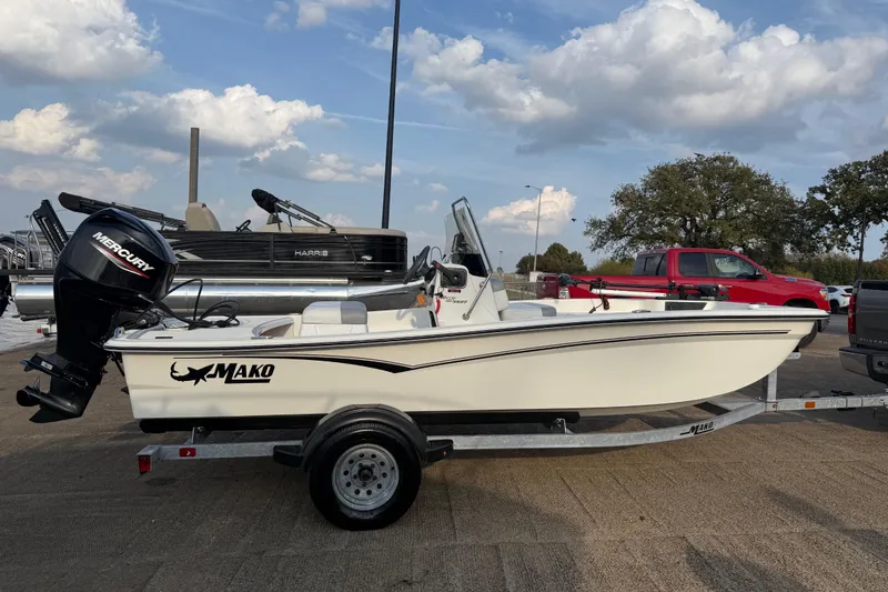 Slide: The Image of 2023 Mako Pro Skiff 15 CC boat on trailer with Mercury outboard motor. - 69