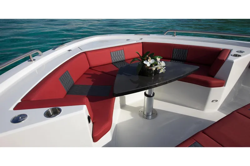 Slide: The Image of Manufacturer Provided Image: Luxurious seating area on 2020 Ocean Alexander 45 Divergence Sport yacht with red cushions and a black table. - 9