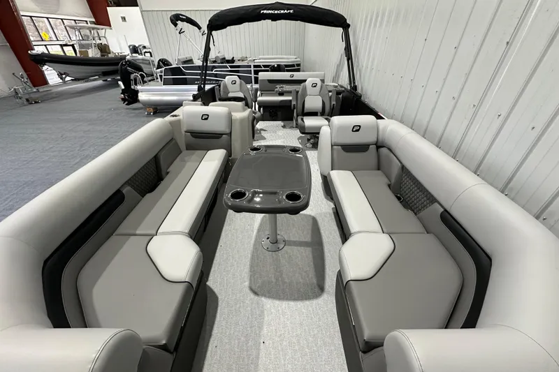Slide: The Image of 2026 Princecraft Vectra 23 RL pontoon boat interior with gray seating and central table. - 15