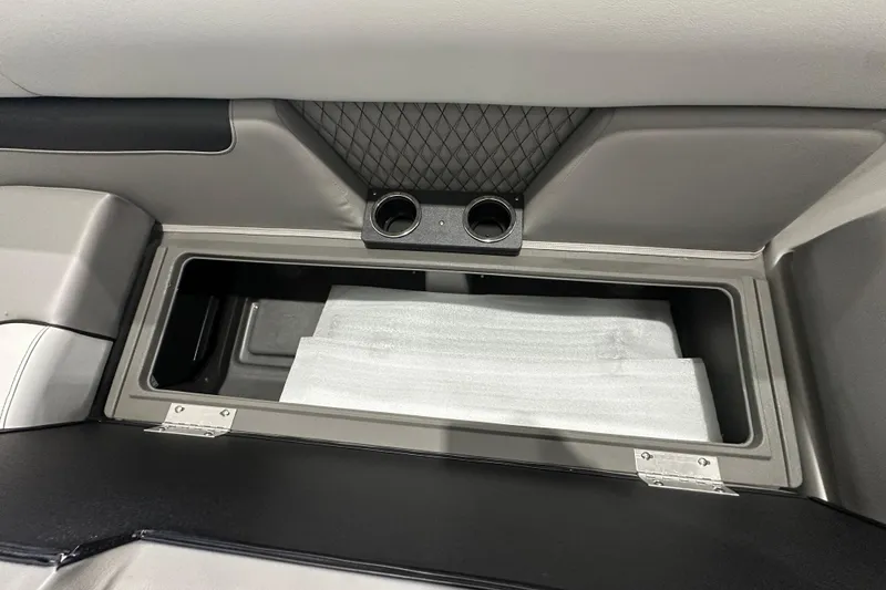 Slide: The Image of Interior storage compartment of 2026 Princecraft Vectra 23 RL boat with cup holders. - 16