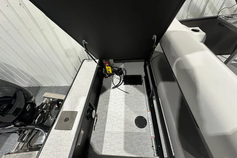 Slide: The Image of 2026 Princecraft Vectra 23 RL boat storage compartment with open lid and visible wiring. - 17