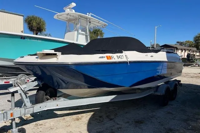 The Image of 2020 Bayliner Element E21 boat on trailer, blue and white exterior, parked outdoors. - 0