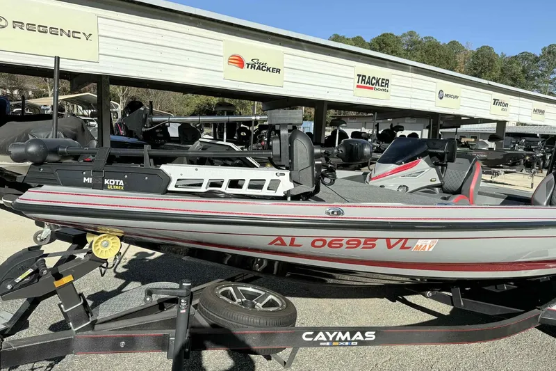 Slide: The Image of 2022 Caymas CX20PRO boat on trailer, featuring Minn Kota Ultrex motor, parked at dealership. - 4