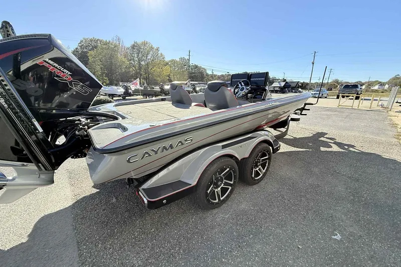Slide: The Image of 2022 Caymas CX20PRO boat with dual console, parked on a trailer in a sunny outdoor setting. - 5
