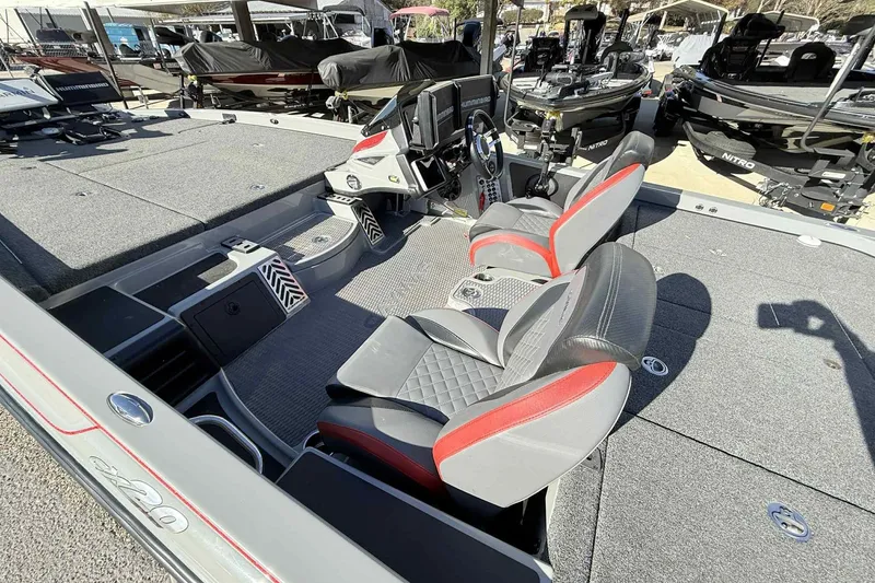 Slide: The Image of 2022 Caymas CX20PRO boat interior with gray and red seating, spacious deck, and modern controls. - 8