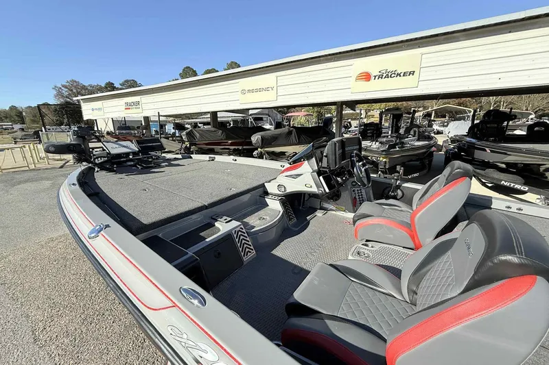 Slide: The Image of 2022 Caymas CX20PRO boat with modern seating and advanced controls at a dealership. - 9