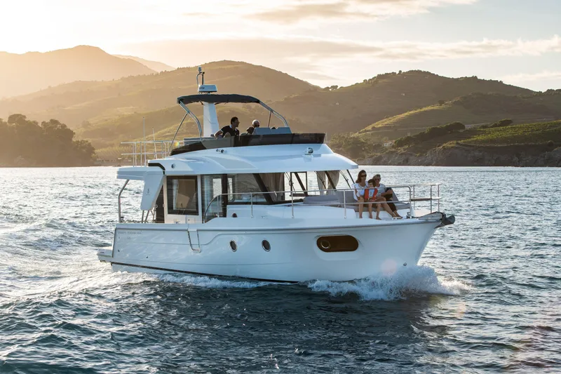The Image of 2026 Beneteau Swift Trawler 41 Fly cruising on scenic waters at sunset. - 0