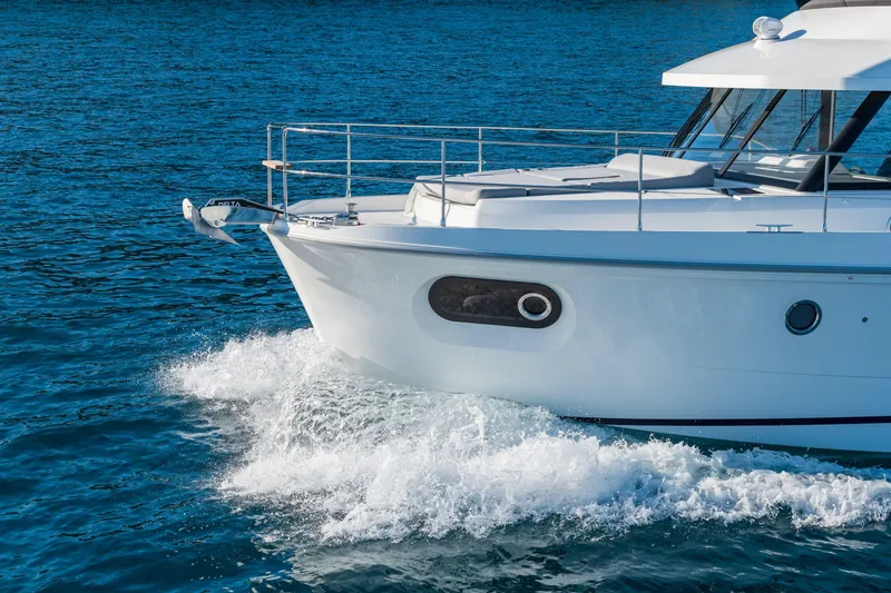 Slide: The Image of 2026 Beneteau Swift Trawler 41 Fly cruising on blue ocean waters. - 16