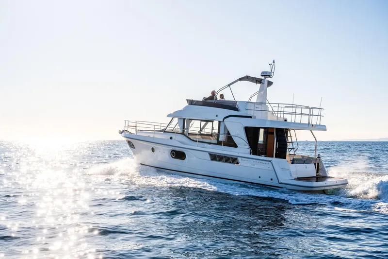 Slide: The Image of 2026 Beneteau Swift Trawler 41 Fly cruising on open water. - 2