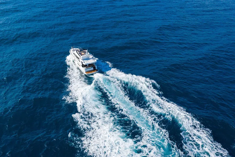 Slide: The Image of 2026 Beneteau Swift Trawler 41 Fly cruising on open blue ocean waters. - 28