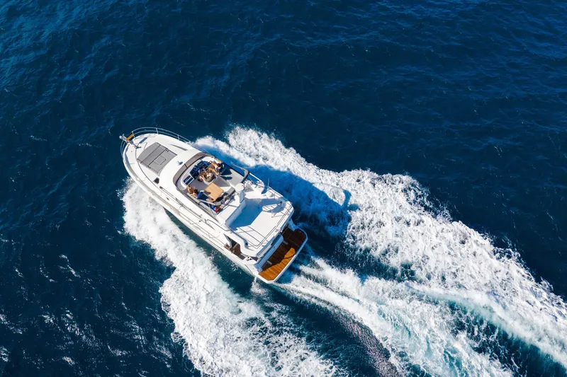 Slide: The Image of 2026 Beneteau Swift Trawler 41 Fly cruising on open blue sea. - 29