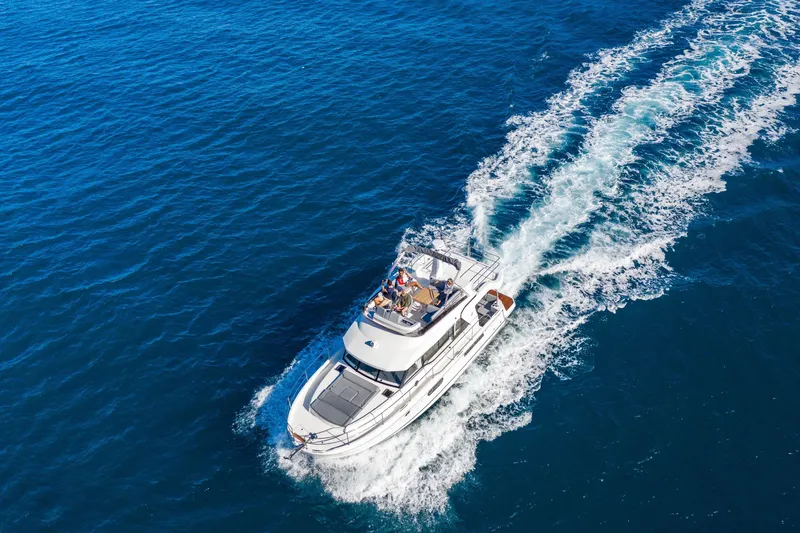 Slide: The Image of 2026 Beneteau Swift Trawler 41 Fly cruising on open blue sea. - 30