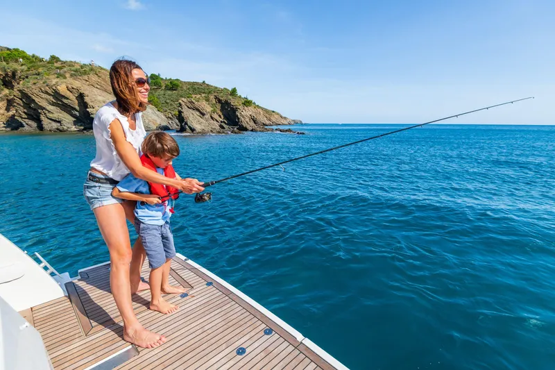 Slide: The Image of Mother and child fishing on a 2026 Beneteau Swift Trawler 41 Fly, scenic ocean view. - 31