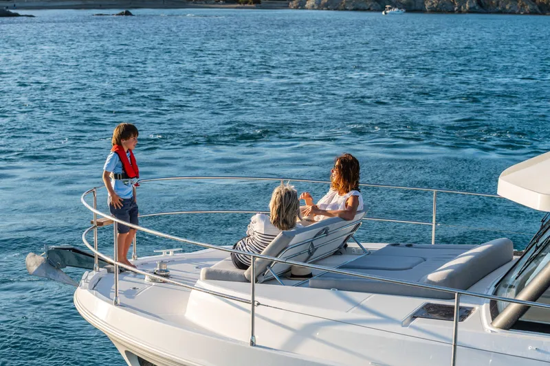 Slide: The Image of Family relaxing on 2026 Beneteau Swift Trawler 41 Fly, enjoying a sunny day at sea. - 5
