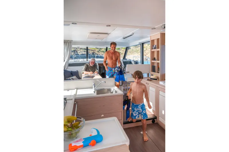 Slide: The Image of Family enjoying the interior of a 2026 Beneteau Swift Trawler 41 Fly yacht. - 6