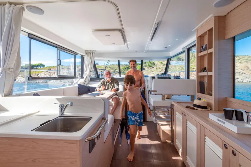 Slide: The Image of Interior of 2026 Beneteau Swift Trawler 41 Fly with family enjoying the spacious cabin. - 7