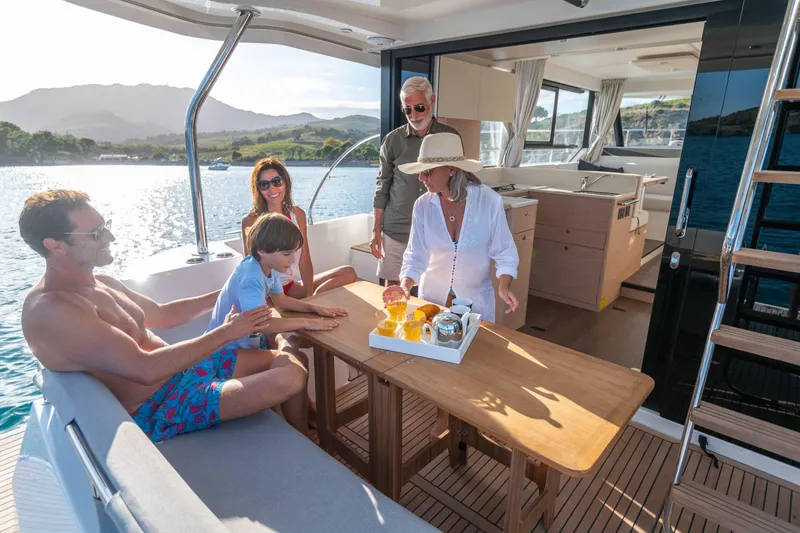 Slide: The Image of Family enjoying leisure time on a 2026 Beneteau Swift Trawler 41 Fly yacht. - 8