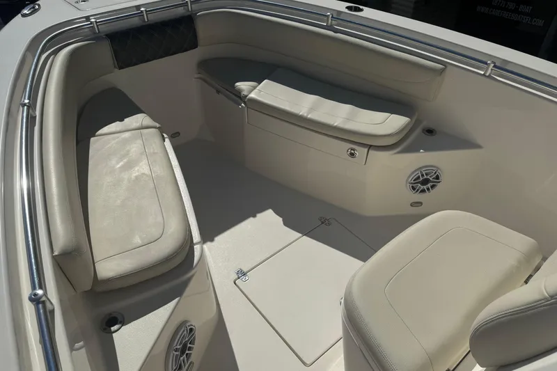 Slide: The Image of 2021 Cobia 262 Center Console boat interior with cushioned seating and speakers. - 12