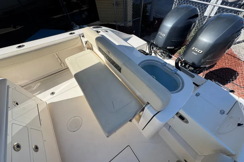 Slide: The Image of 2021 Cobia 262 Center Console boat with dual Yamaha 150 engines and seating area. - 5