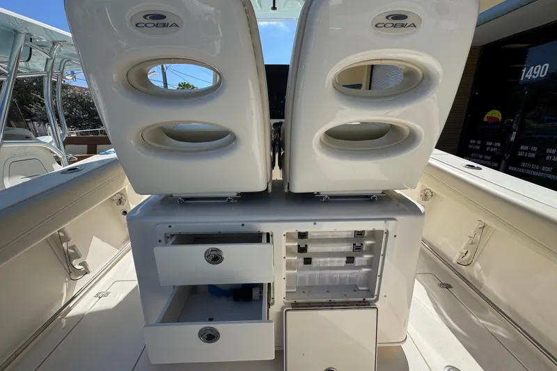 Slide: The Image of 2021 Cobia 262 Center Console boat interior with storage compartments and seating. - 7