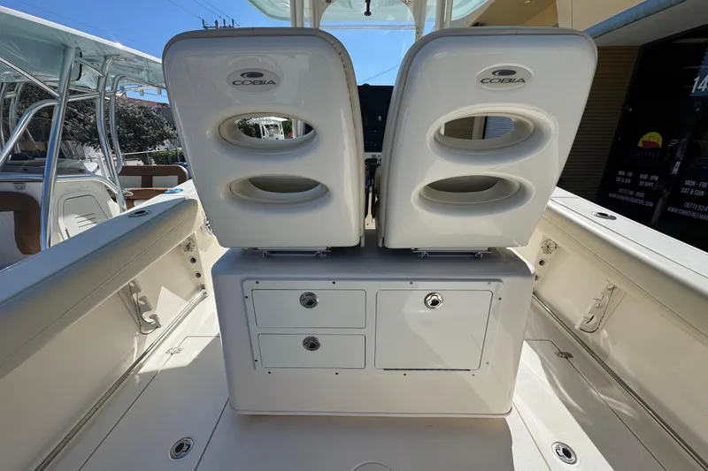 Slide: The Image of 2021 Cobia 262 Center Console boat interior with dual seats and storage compartments. - 8