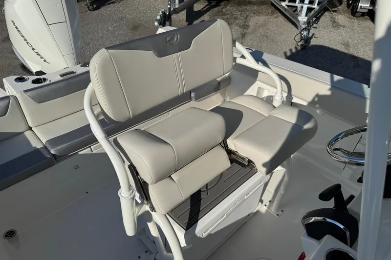 Slide: The Image of 2026 Sailfish 232 CC boat interior with beige seating and steering wheel. - 12