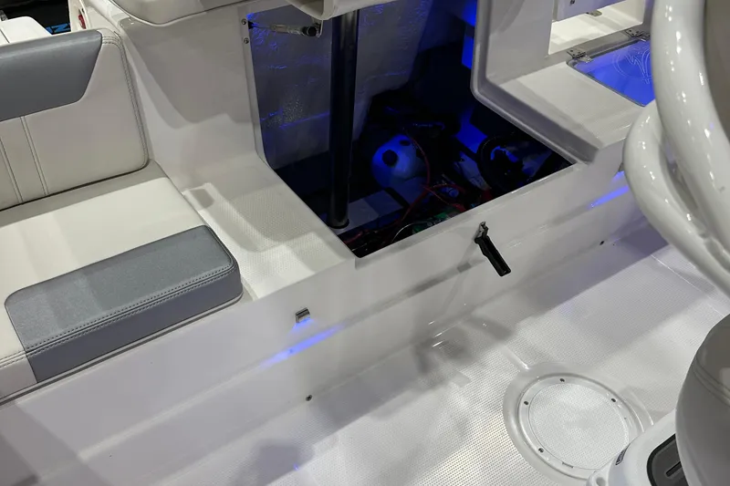 Slide: The Image of 2026 Sailfish 232 CC boat interior with open storage compartment and seating. - 17