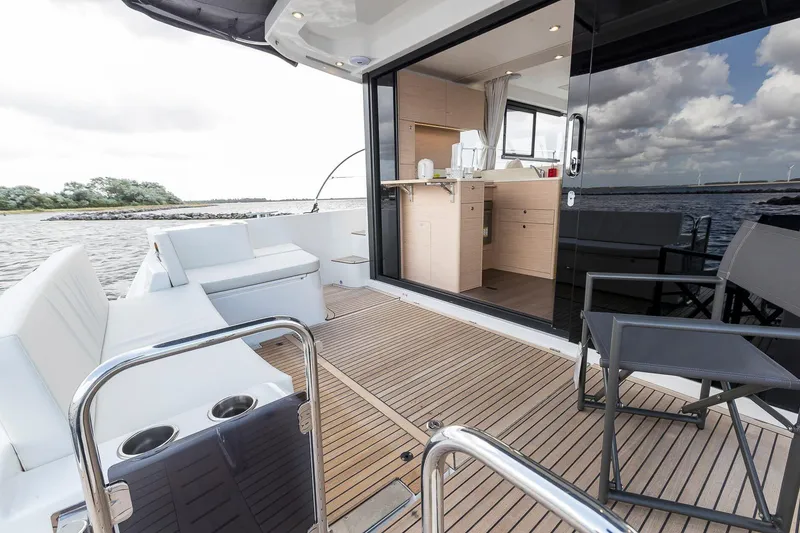 Slide: The Image of 2026 Beneteau Swift Trawler 41 Sedan, spacious deck with modern interior and scenic water view. - 10