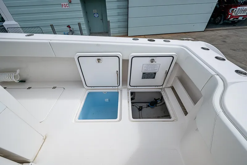 Slide: The Image of Invincible 40 Catamaran 2021 deck with storage compartments and access hatches. - 16