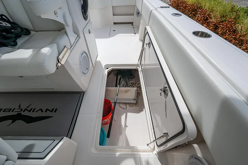 Slide: The Image of 2021 Invincible 40 Catamaran storage compartment with cleaning supplies and equipment. - 18