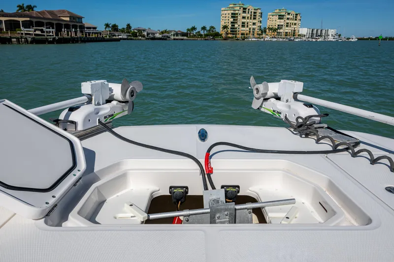 Slide: The Image of 2021 Invincible 40 Catamaran deck with open storage compartments and scenic waterfront view. - 28