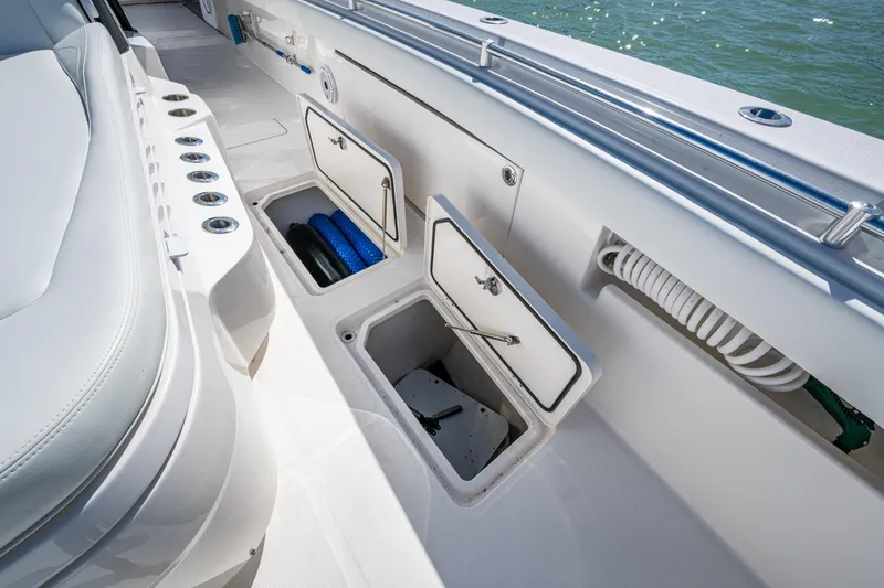 Slide: The Image of 2021 Invincible 40 Catamaran deck storage compartments with open hatches and visible equipment. - 34