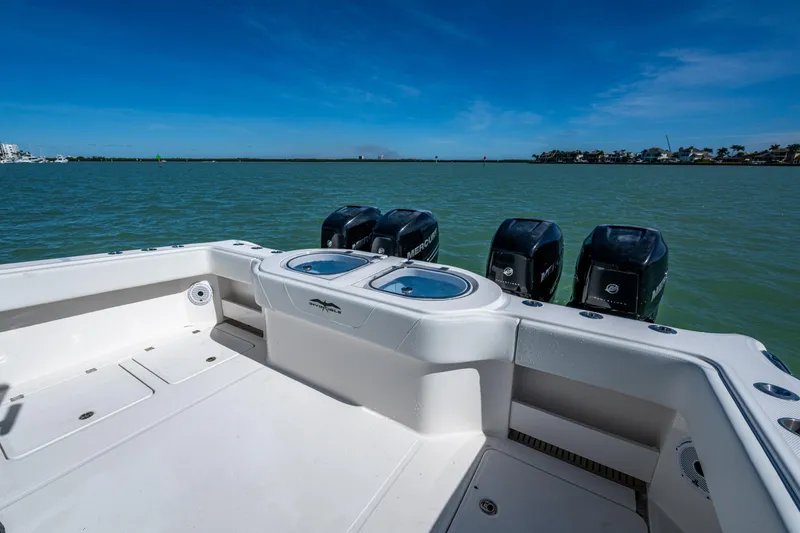 Slide: The Image of Invincible 40 Catamaran 2021 with powerful outboard motors on a calm sea. - 36
