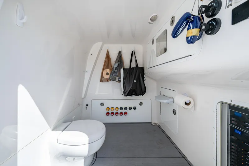 Slide: The Image of Interior of 2021 Invincible 40 Catamaran bathroom with toilet and storage. - 47