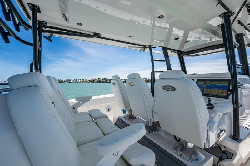 Slide: The Image of Interior of 2021 Invincible 40 Catamaran with white seating and advanced navigation system. - 53