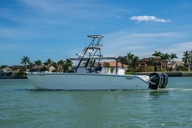 Slide: The Image of 2021 Invincible 40 Catamaran cruising on a sunny day near waterfront homes. - 58